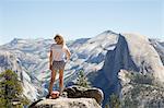 Girl looking at view with Sentinel Dome and Yosemite Falls