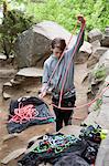 Boy with climbing ropes among rocks