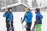 Men with skis standing on snow