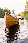 Man paddling on lake