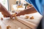 Man planning wood in workshop