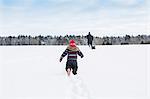 Rear view of child playing in snow