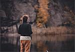 Rear view of woman at lake in Flaten, Sweden