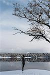 Man by lake in Sodermanland, Sweden