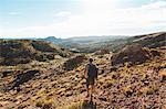 Man hiking in mountains in Arches National Park