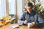 Man wrapping christmas gifts