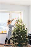 Woman decorating christmas tree