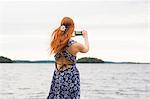 Woman photographing sea