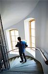 Man walking on steps, carrying box