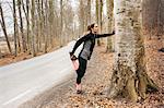 Young woman stretching in Sodermanland, Sweden