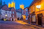 View of illuminated Lincoln Cathedral viewed from the cobbled Steep Hill at dusk, Lincoln, Lincolnshire, England, United Kingdom, Europe