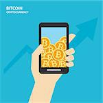 Bitcoin on smartphones with human hand. Cryptocurrency market concept.