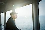Man on ferry looking away out of window
