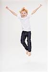 Portrait of boy leaping in air