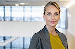 Portrait of confident mature businesswoman in office atrium