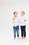 Studio portrait of two boys, full length