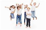 Studio portrait of two boys and four girls having fun jumping mid air, full length