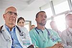 Attentive surgeons, doctors and nurses listening in meeting