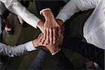 Business people joining hands in a circle in the office. concept of teamwork and partnership
