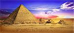 Pyramids in desert under ultra violet clouds