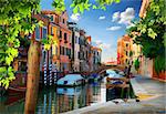 Boats in narrow venetian water canal, Italy