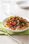 Spicy ground beef with peppers and couscous  on a green napkin with a fork