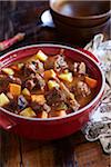 Oxtail stew in a casserole dish with root vegetables