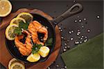 Fried or grilled salmon fillet on cast-iron pan with