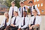 Portrait Of Teenage Students In Uniform Outside School Buildings