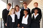 Portrait Of Teenage Students In Uniform Outside School Building