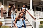 Four teen girlfriends leaving house for school