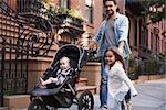 Family taking a walk down the street, close up