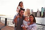 Young family with daughters standing on quayside, close up