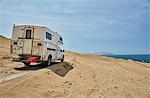 Campervan on sandy track along coast, Laguna Grande, Ica, Peru