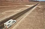 High angle view of campervan parked on desert roadside, Hacienda Ventilla, Ica, Peru