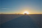 Woman exploring salt flats, recreational vehicle in background, Salar de Uyuni, Uyuni, Oruro, Bolivia, South America