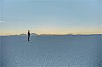 Woman standing on salt flats, looking at view, Salar de Uyuni, Uyuni, Oruro, Bolivia, South America