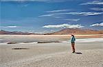 Woman standing, looking at view, Laguna Colorada, Colorada, Potosi, Bolivia, South America