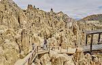 Mother and sons trekking along footpath, through rock formations, La Paz, Bolivia, South America