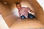 Portrait of boy playing in cardboard box