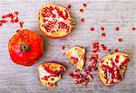 Pomegranate pieces and seeds on table