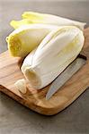 Chicory with a knife on a chopping board