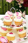 Rose petal cupcakes on the cake stand decorated with roses