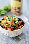 A chickpea bowl with cherry tomatoes and curry leaves