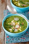 Spinach soup with egg and red radishes