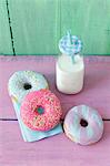 Doughnuts with a colorful sugar glaze and a milk bottle