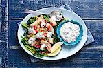 Fried cod with spinach, pomegranate and herb yogurt sauce