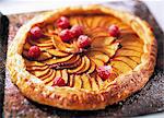 A whole french apple tart on a baking tray