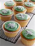 Cupcakes with a white shamrock on top of the green icing