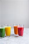 Various fresh cold-pressed juices (green juice, apple and lemon juice, carrot juice, watermelon juice)